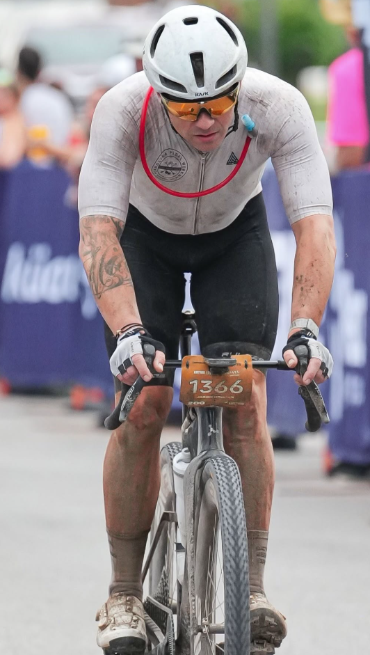 Rider crossing the Unbound 200 finish line on Commercial St